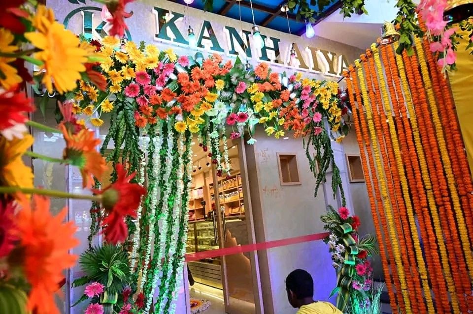 Kanhaiya Sweets grand entrance decorated with flowers and marigold garlands