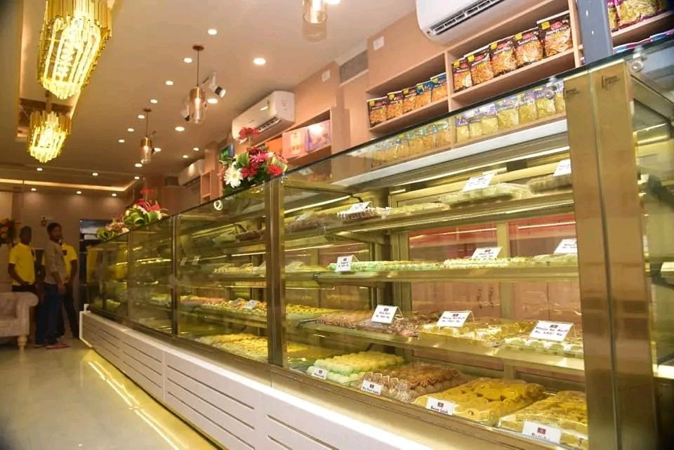 Wide display counter filled with fresh Indian sweets